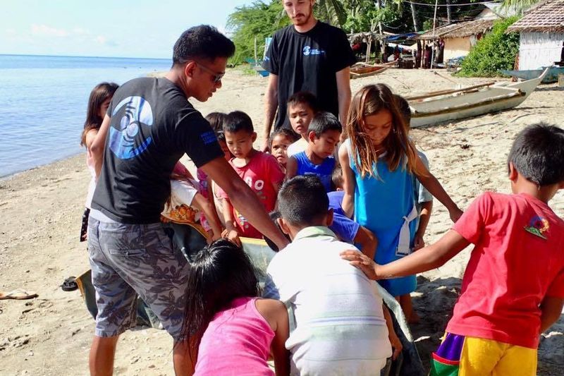 MCP volunteers running an activity with local children on the beach